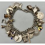 An Antique 925 Silver Charm Bracelet Created from an Albert Chain. Eclectic charms including old