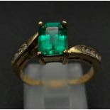 A 9k gold, green and white stone ring. Size N 1/2. 2.78g total weight.