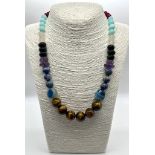 A Colourful Jade, Lapis Lazuli, Tigers Eye, Amethyst and Onyx Graduated Bead necklace. 8-16mm beads.