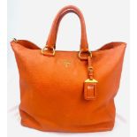 A Prada Burnt Orange Tote Bag. Soft leather with gilded hardware. Inner zipped and flap