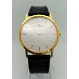 A Baume and Mercier 18K Gold Gents Watch. Original black leather strap. 18k gold case - 32mm.