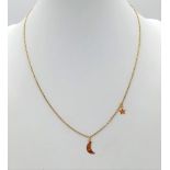 A 14K yellow gold chain necklace with two pendant/ charms a half moon and a star. Chain length: 41