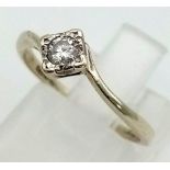 A 9K white gold, compass set, diamond solitaire, twist ring (diamond 0.15 carats). Ring size: J,