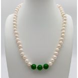 An Akoya Cultured Pearl Necklace with a Green Jade Bead Compliment. White stone spacers. 40cm -