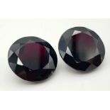 A Pair of 67.32ct Round Brilliant Shaped Dark Red Garnets. 20mm. AIG Milan Certified.