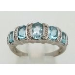 A fancy, 9 K white gold ring with diamond and blue topaz. Size: P, weight: 3.9 g.
