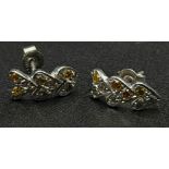 A Pair of fancy natural multi-coloured diamond stud earrings set in 18K white gold. Ref:15