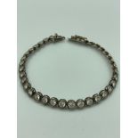 SILVER TENNIS BRACELET having 35 sparkling gemstones individually set in circular Silver mounts.