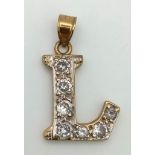 A 9 K gold , initial L, stone set, pendant. Weight: 1.8 g.