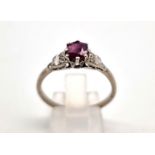 An 18 k white gold diamond (0.20 carats) and ruby (0.75 carats). Size: T, weight: 3.5g.