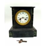 An Antique Victorian Marble/Slate Mantel Clock. Comes with key. In good working order but because of