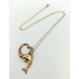 A Swinging 9K Gold Heart and Dolphin Pendant on a 9K Gold Disappearing Necklace. 2 and 40cm. 1.05g