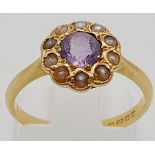 A Vintage 18K Yellow Gold Amethyst and Opal Ring. Central amethyst with a halo of small opals.
