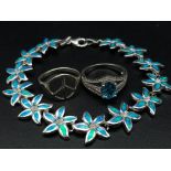 A sterling silver lot including a bracelet with synthetic blue opal flowers, a ring with cubic