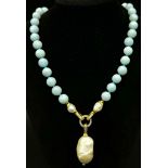 A Blue Aquamarine Necklace with a Gold Plated Drop to a Large Natural Baroque Pearl. Beads - 10mm.