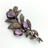 A Vintage marcasite and amethyst floral decorative large brooch set in silver. 7cm. Ref: 21
