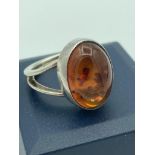 Vintage SILVER and AMBER RING, having large oval AMBER CABOCHON set to top with Attractive SILVER