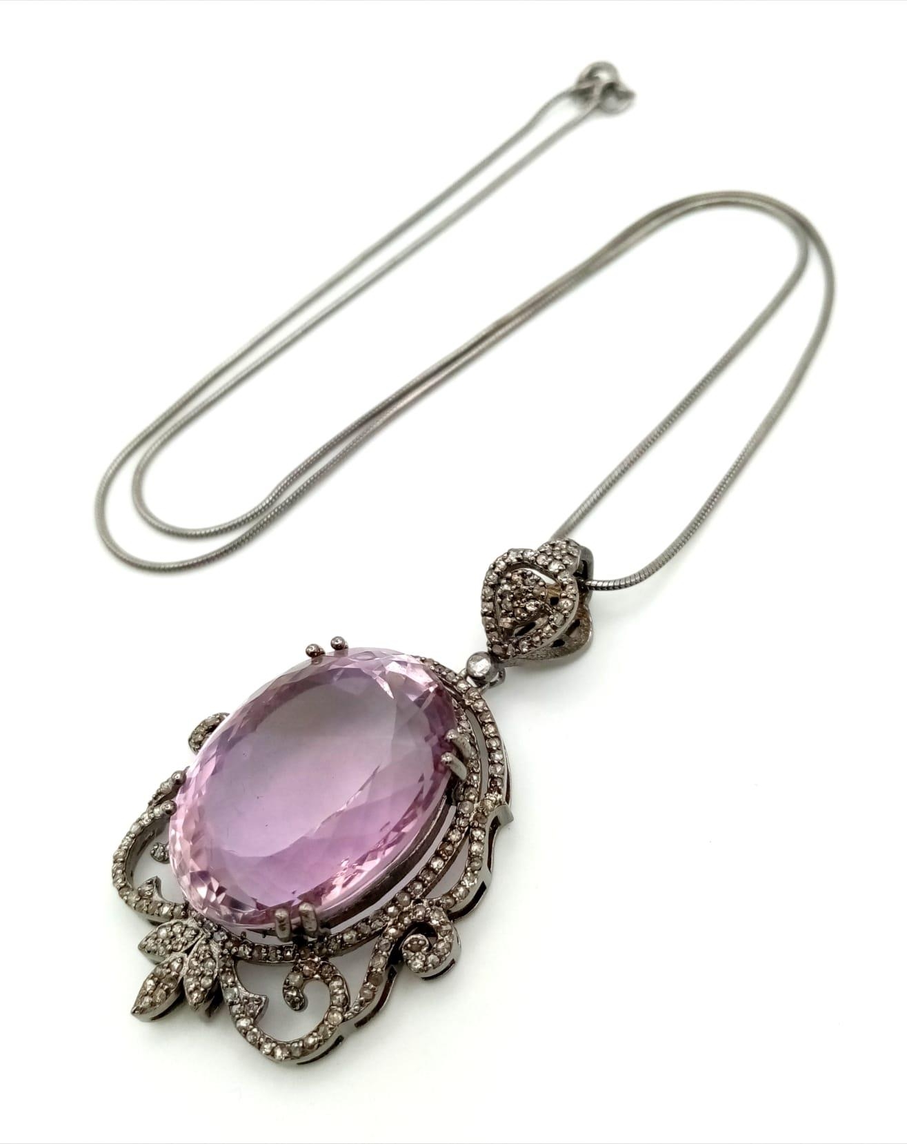 A 42.75ct Natural Oval cut Amethyst Pendant, set in 925 silver, decorated with a Diamond surround.