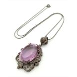 A 42.75ct Natural Oval cut Amethyst Pendant, set in 925 silver, decorated with a Diamond surround.