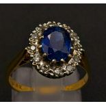 An 18K gold sapphire and diamond cluster ring. Size M 1/2. 3.68g total weight. Ref: 13.