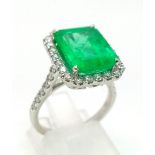 A 950 Platinum 6.19ct Colombian Emerald and Diamond Ring. Octagonal mixed cut emerald with a diamond