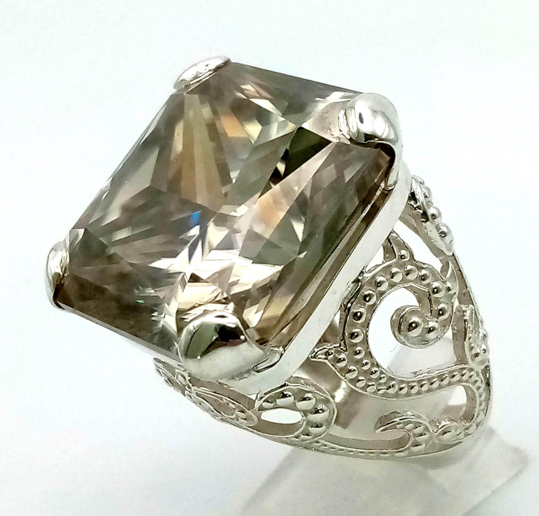 A Rare 79.4ct Brandy Shade Moissanite Ring set in 925 Silver. Size S. 31g total weight.