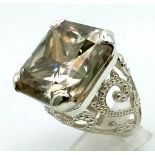 A Rare 79.4ct Brandy Shade Moissanite Ring set in 925 Silver. Size S. 31g total weight.