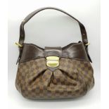 A Louis Vuitton Damier Ebene Sistina PM Bag. Brown checked canvas with brown leather and gilded
