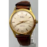 A Vintage Mudu Doublematic Gents Watch. Brown leather strap. Gilded case - 35mm. In working order.