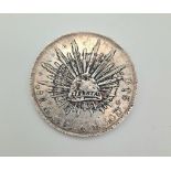 An 1895 Mexico 8 Reales Silver Coin. Please see photos for conditions.