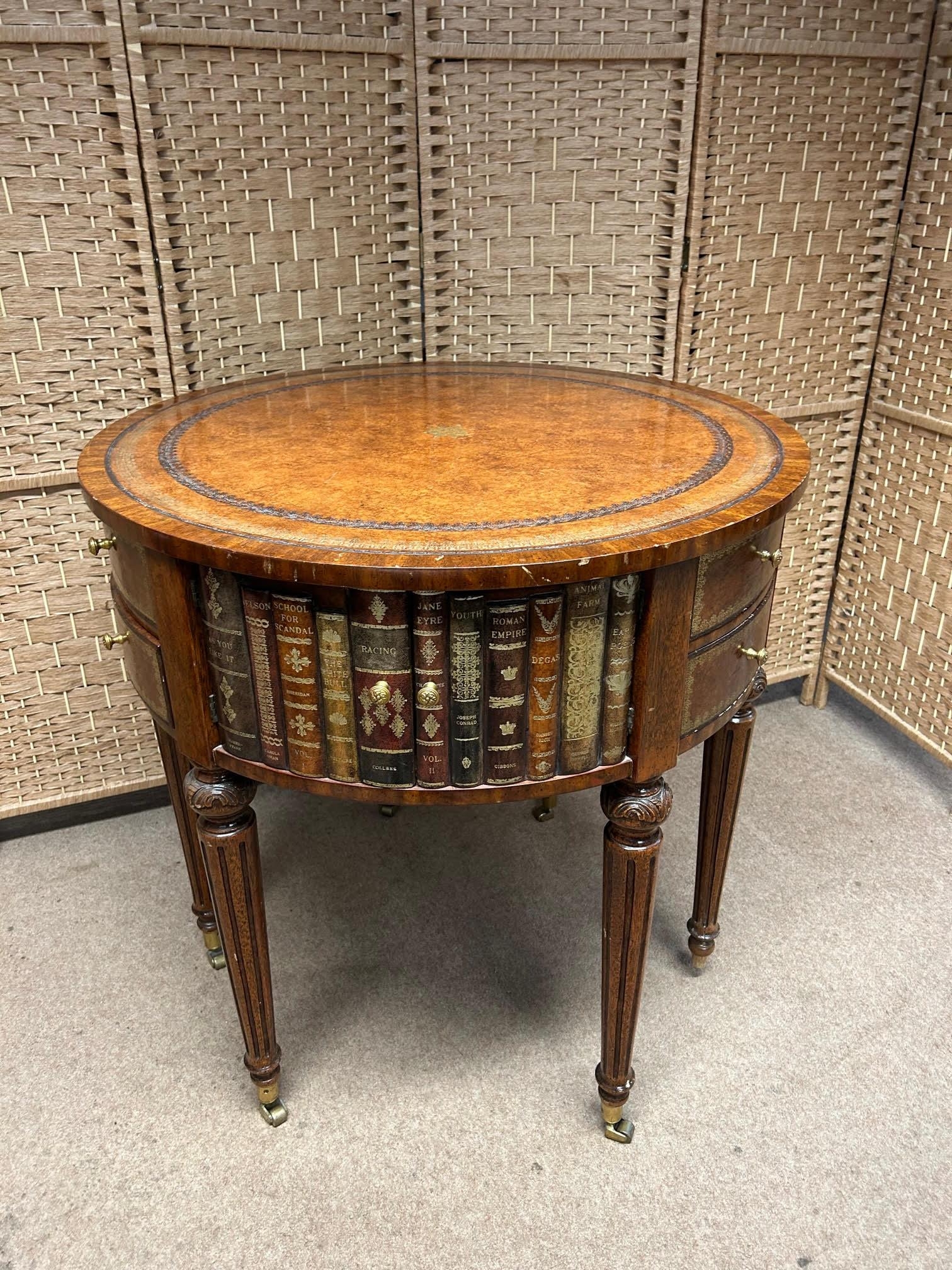 Maitland Smith Round Leather-Wrapped Book Motif Design Side Table on Castors. There are three sets