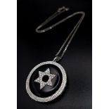 AN 18K WHITE GOLD STAR OF DAVID DIAMOND PENDANT WITH BLACK ONYX ON A 18K GOLD 42cms CHAIN.