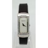 A Tiffany and Co 18K Gold and Diamond Ladies Watch. Black leather strap with Tiffany white gold