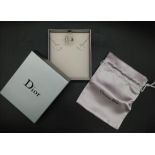 A Christian Dior Earring and Ring Set. White metal and white stone. Ring k 1/2. Comes with a
