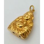 An 18 K yellow gold Buddha charm. Weight: 1.4 g.