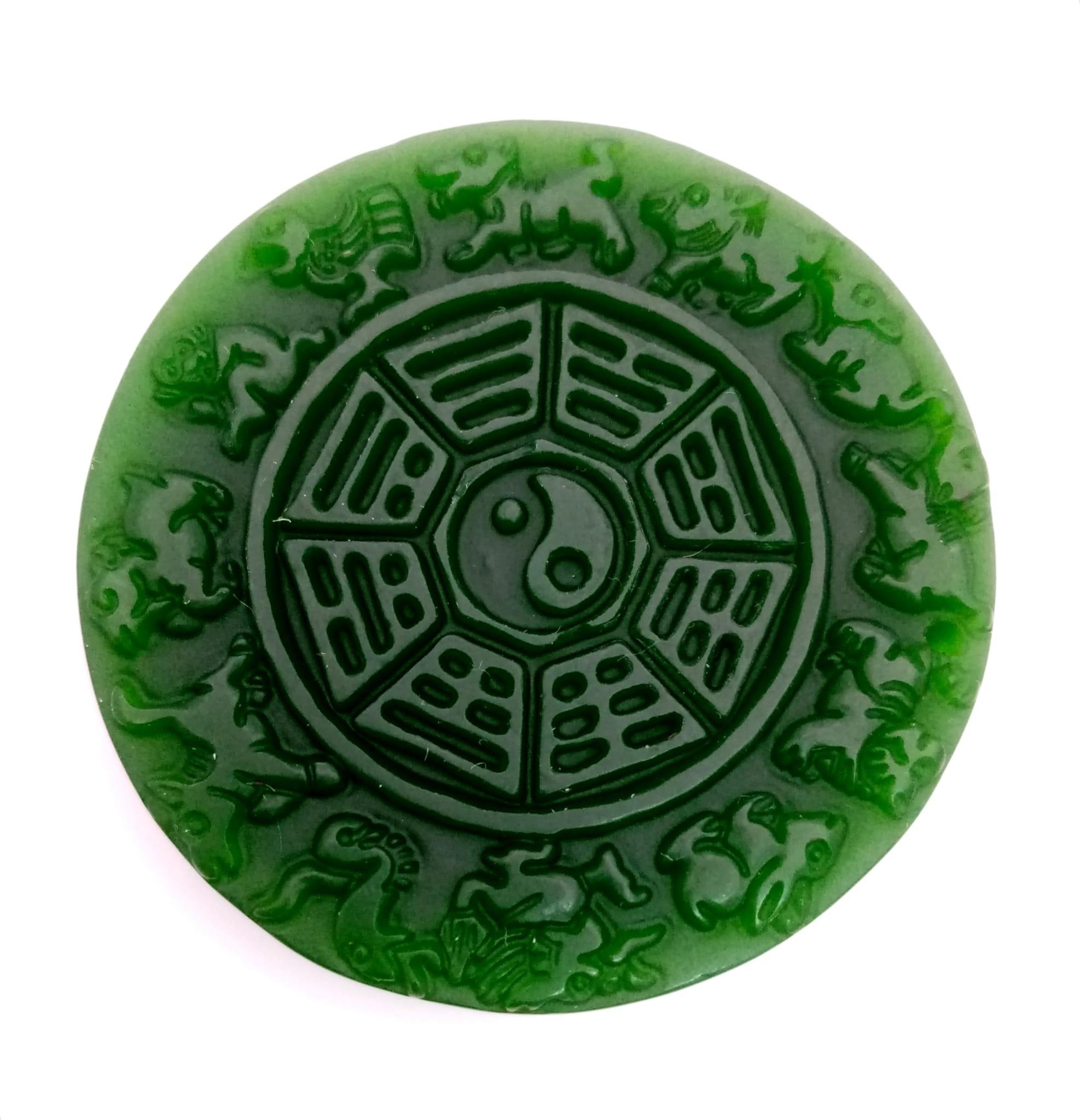 A Chinese Green Jade Astrology Pendant. 5cm diameter.