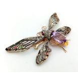 An articulated winged butterfly brooch with fine amethyst, diamonds, rubies and sapphires. Set in 9k