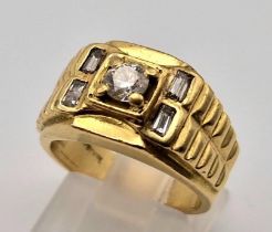 An 18 K yellow gold ring. Rolex style with round (0.45 carats) and baguette (0.25 carats)