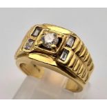 An 18 K yellow gold ring. Rolex style with round (0.45 carats) and baguette (0.25 carats)