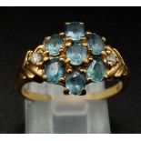 9K YELLOW GOLD, DIAMOND & TOPAZ FANCY CLUSTER RING. WEIGHS 3.1G. SIZE M