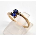 A stumped as 585, but tested as 12 K yellow gold diamond and blue stone ring. Size: N, weight: 1.8