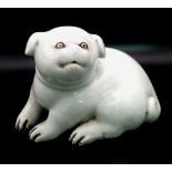 AN ANTIQUE JAPANESE HIRADO PORCELAIN OKIMONO FIGURE OF A PUPPY FROM THE EDO PERIOD . 17cms LONG