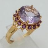 A Gold Plated 925 Silver Amethyst Ring. Central amethyst surrounded by a halo of smaller