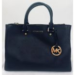 A Michael Kors Black Leather Handbag. Multiple inner compartments. 33cm width by 25cm height.