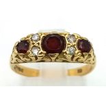 A Glorious Antique 18K Yellow Gold, Garnet and Diamond Ring. Three garnets and four diamonds in a
