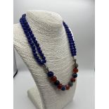 A Stylish Multi-Coloured Onyx Bead Necklace. A row of double strand blue onyx beads connect to a