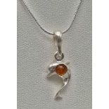 A Baltic Amber Silver Dolphin Pendant on a Silver Necklace. 44 and 2cm.