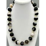 A Black and White Banded Quartz Necklace. With gilded spacers and clasp. 44cm