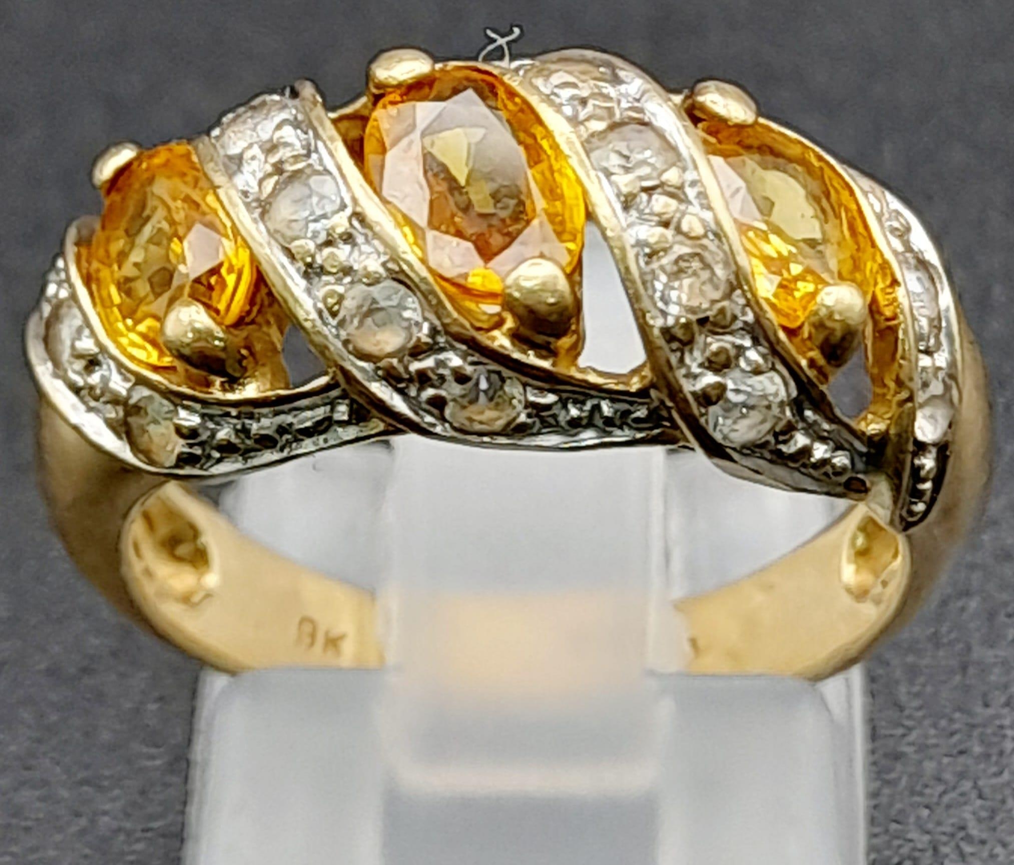 A Vintage 9K Yellow Gold Citrine and Diamond Ring. Three diagonal waves of bright citrine