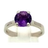 A very elegant platinum ring, with a round cut amethyst (1.5 carats appr). Ring size: M, weight: 5.